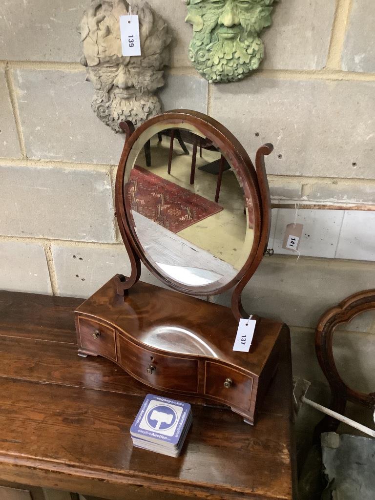 A George III mahogany serpentine box base toilet mirror, width 44cm, depth 20cm, height 58cm